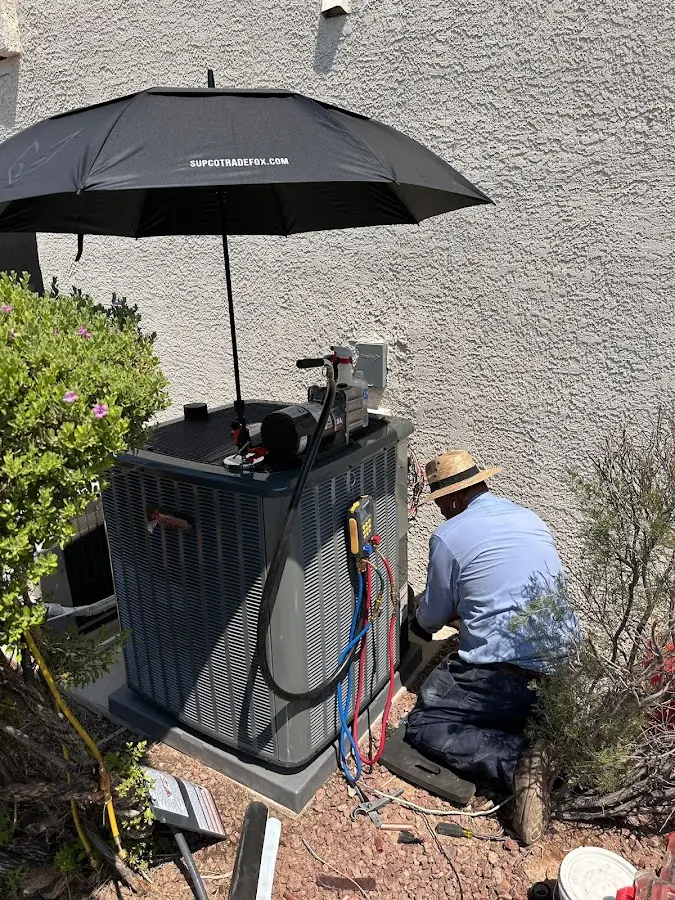 HVAC technician performing outdoor AC maintenance in Marion